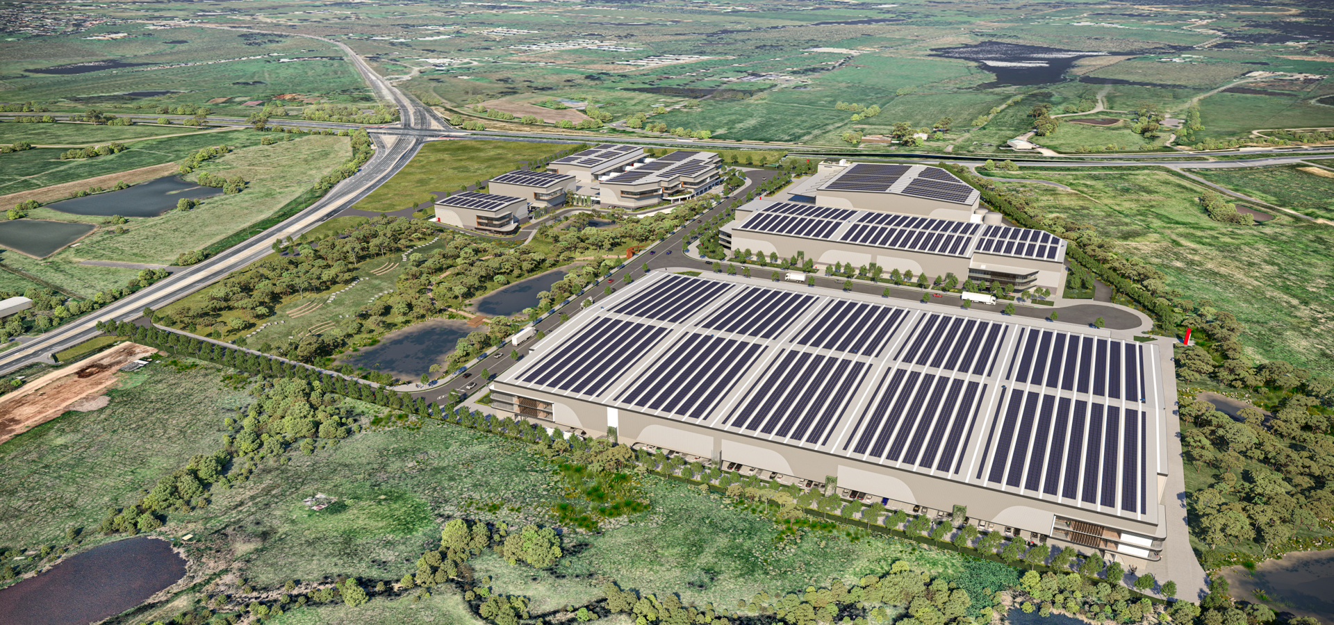Aerial view of a large industrial park with solar panels on the buildings.