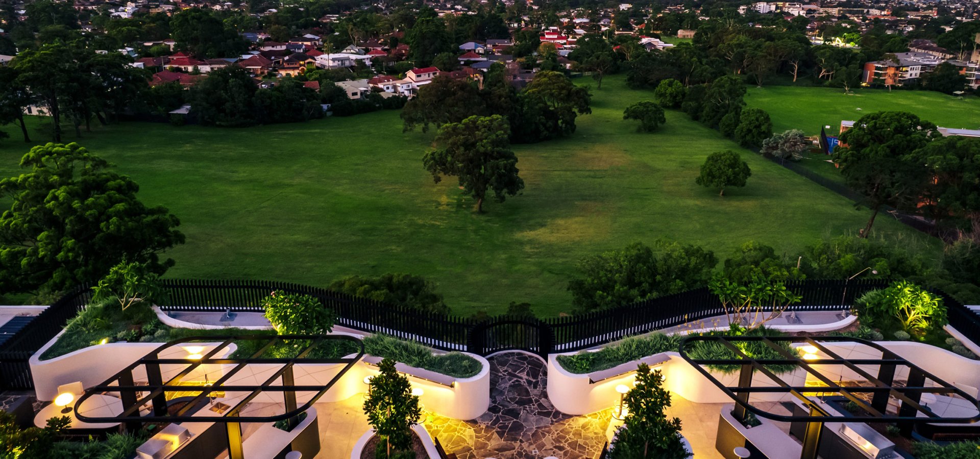 A view of a green field and a city.