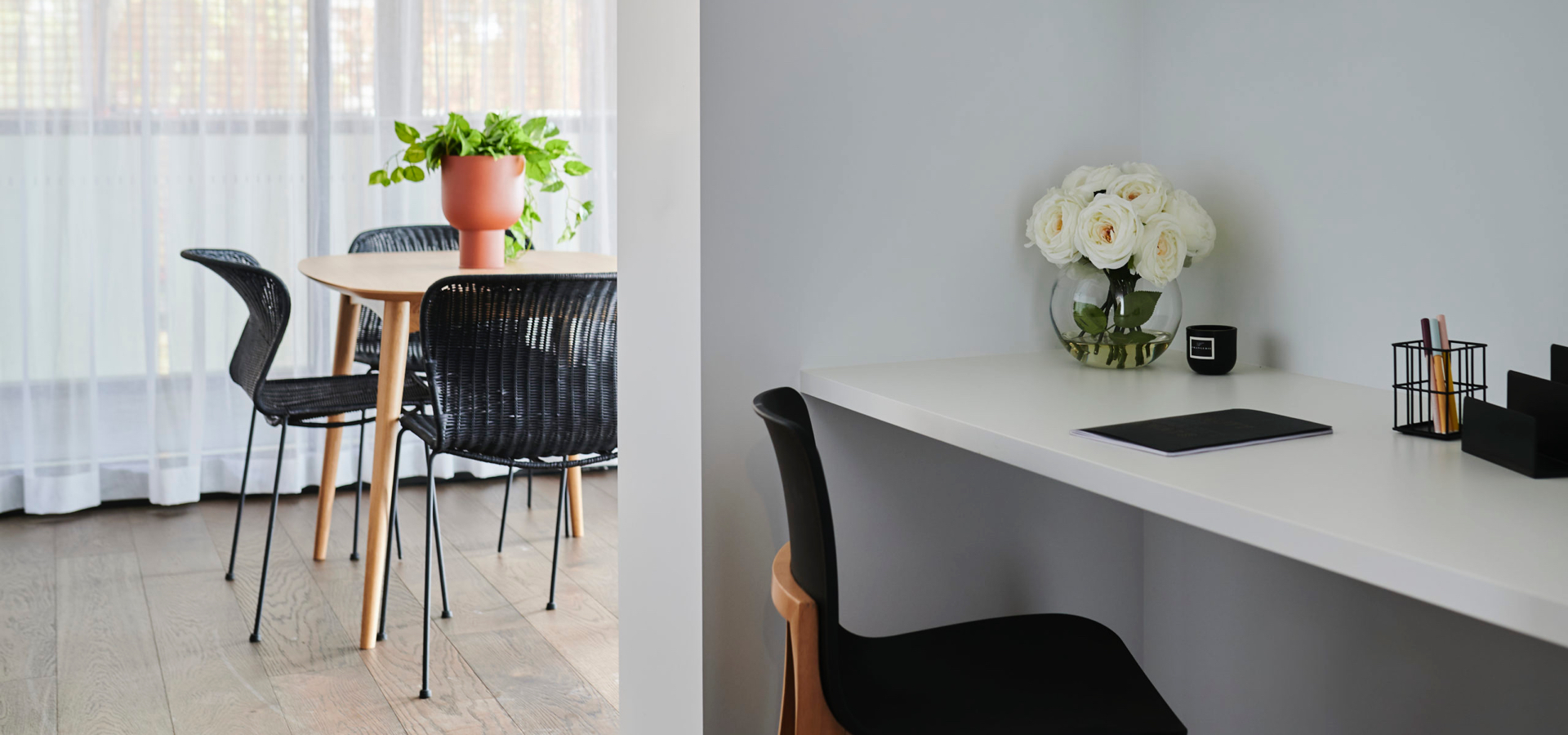 An office nook with a kitchen table with chairs and vase behind it.