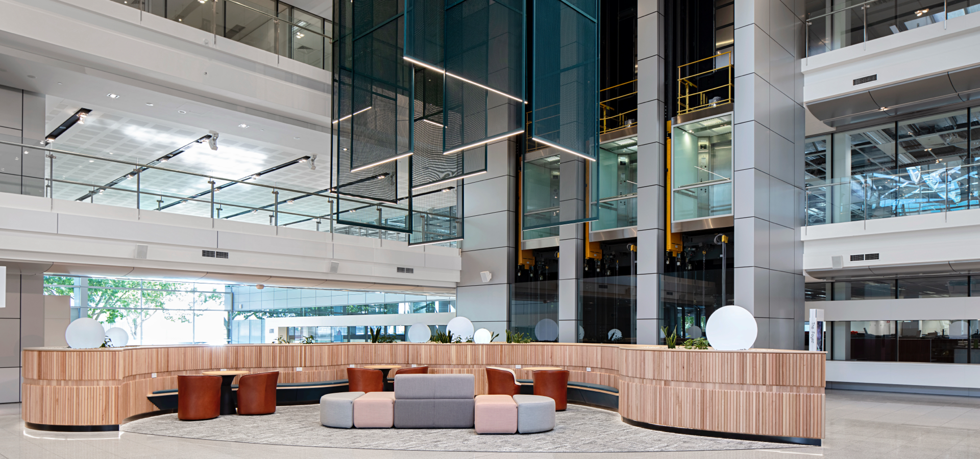 A lobby with a reception desk and chairs.