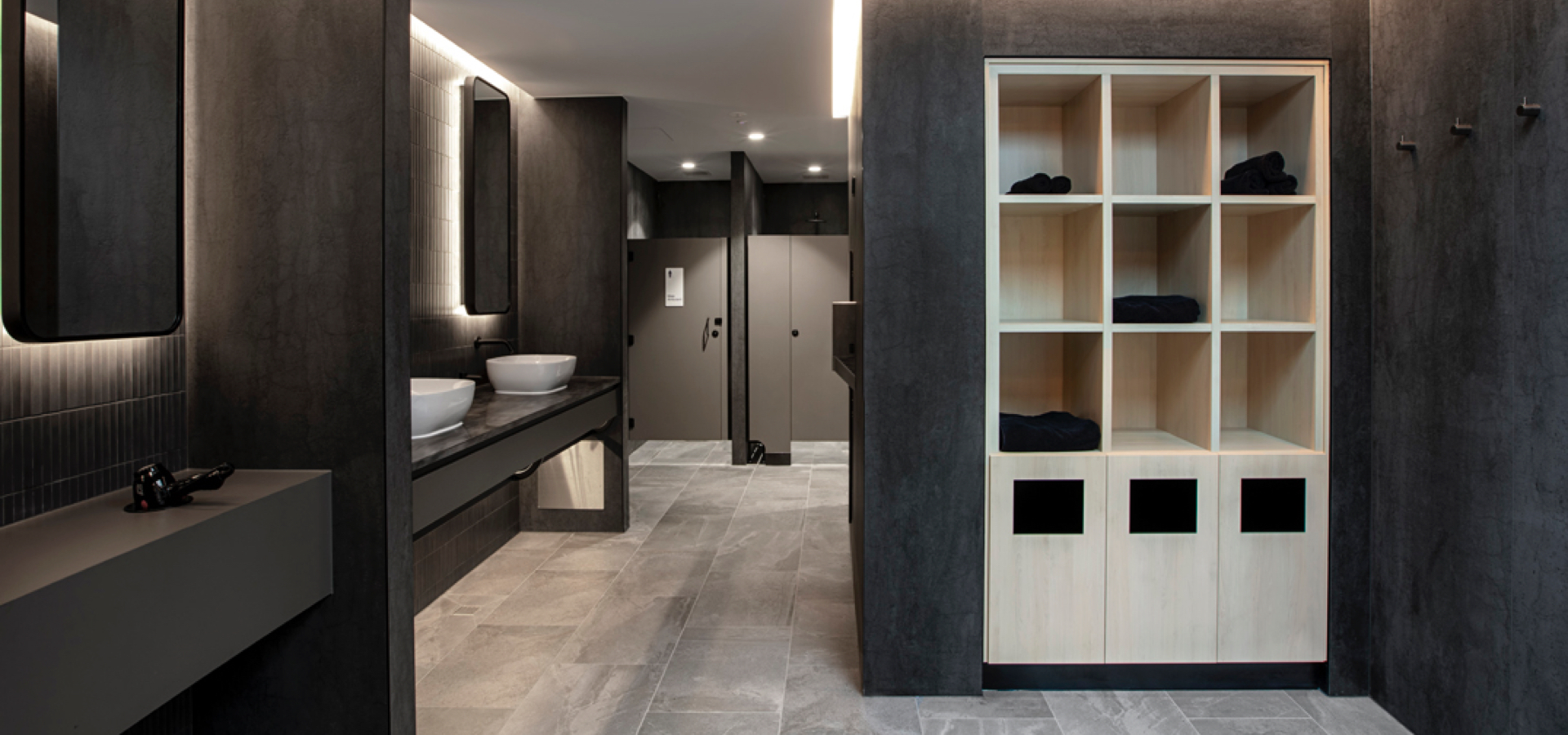 A workout changing room with a sink and shelves.