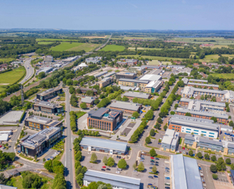 Aerial view of an industrial park with red and black, brick buildings.